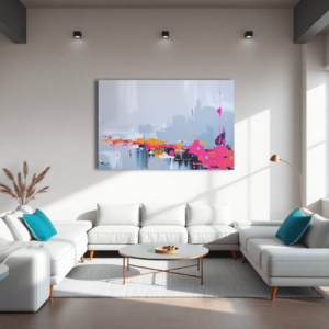 A living room with a white sectional sofa and a canvas print featuring bold color splashes in pink, orange, and yellow against a gray background.