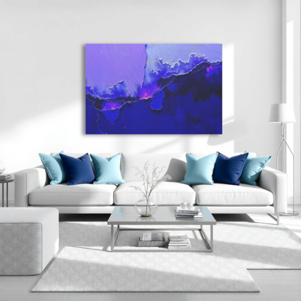 A living room with a white couch and a canvas print featuring an abstract design with purple and blue tones, resembling layered textures.