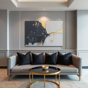 A living room with a gray sofa and a canvas print featuring an abstract design with gold accents and a textured, layered effect.