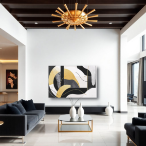 A living room with dark sofas and a canvas print featuring an abstract design with geometric shapes, fluid lines, and a black, white, and gold palette.