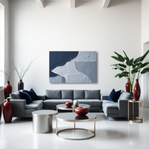 A living room with a gray sectional sofa and a canvas print featuring an abstract design with gray and navy tones, resembling layered textures.