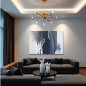 Canvas art featuring fluid, organic shapes in black, white, and gray tones, displayed above a gray sofa in a modern living room.