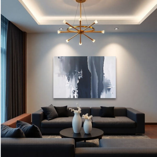 Canvas art featuring fluid, organic shapes in black, white, and gray tones, displayed above a gray sofa in a modern living room.