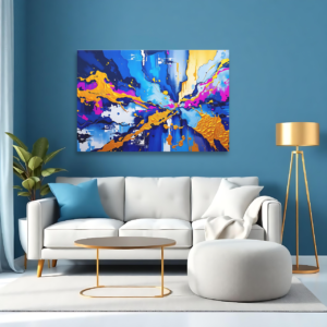 A blue room with a white sofa and a canvas print featuring a dynamic abstract explosion of blue, gold, and pink hues.